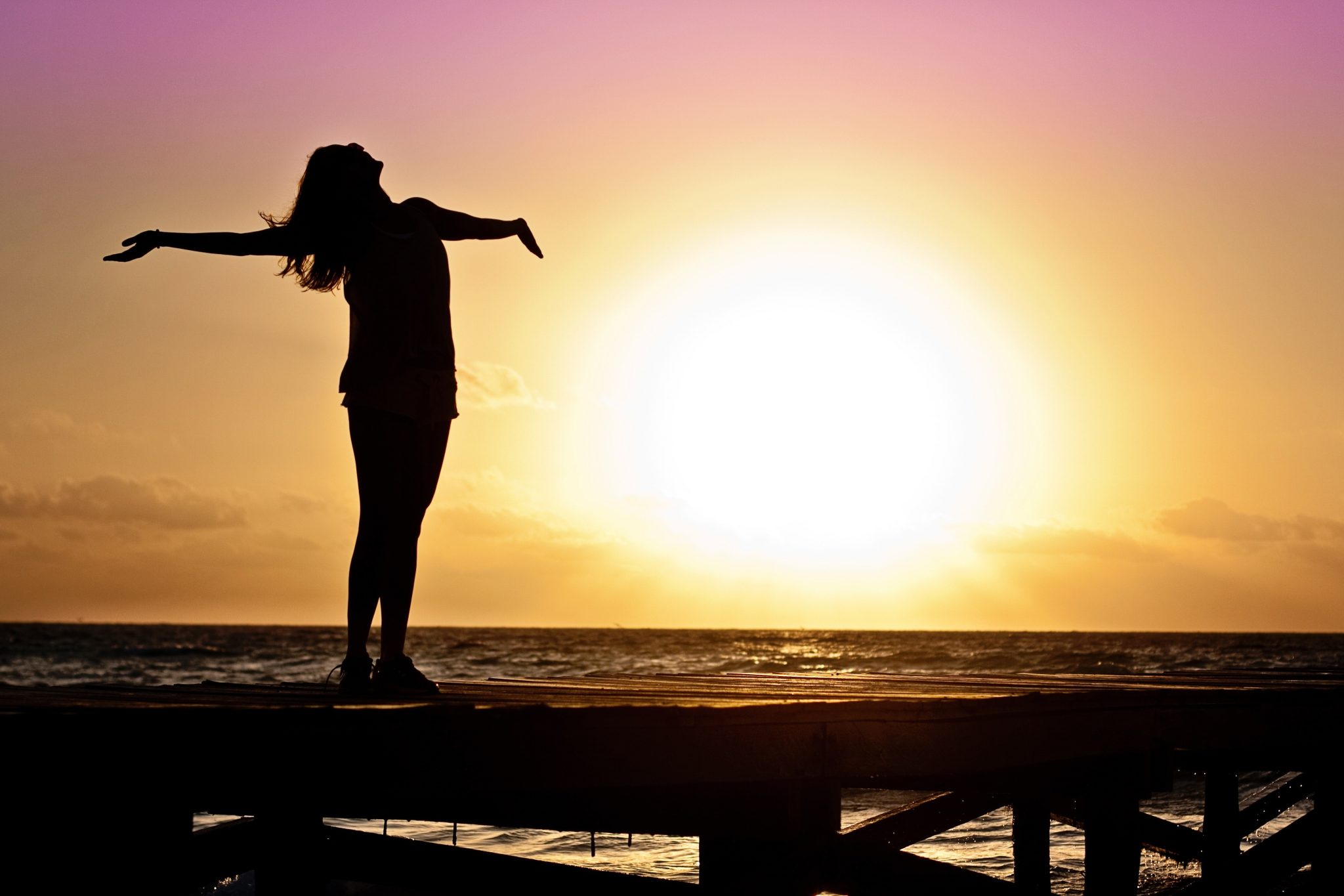 happy woman breathing in sunset glow